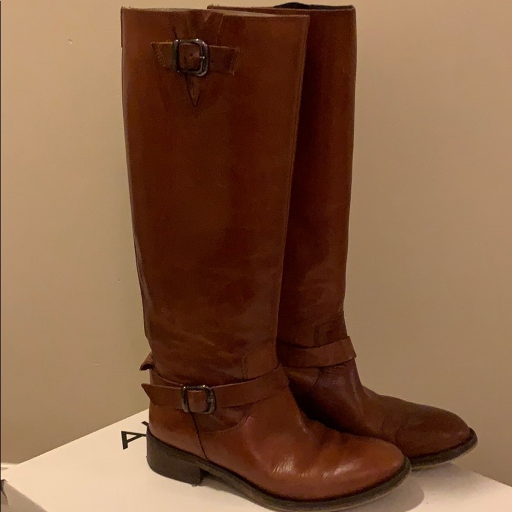 Women’s cognac leather riding boots.